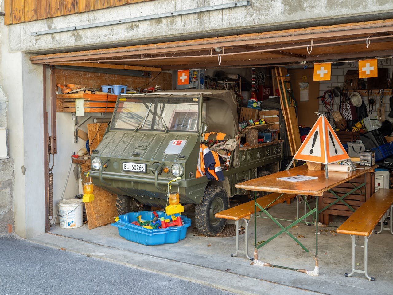 Military vehicle in a crowded garage. Image by Pexels