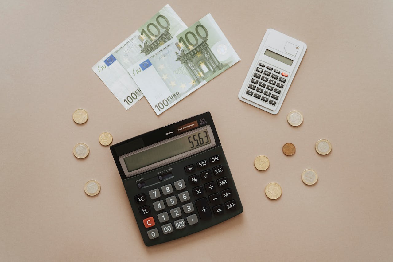 money and a calculator on a table. Image by Pexels